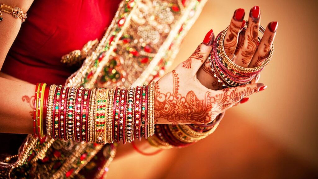 A bride wearing bangles in a modern asian wedding