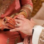 A couple wearing ring in a modern asian wedding